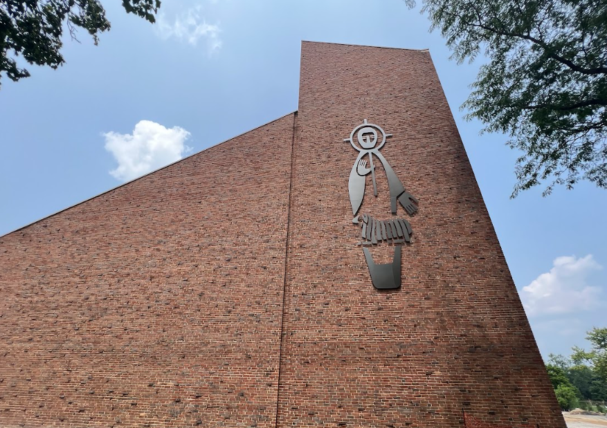 Giant Jesus silhouette on the brick wall of a church